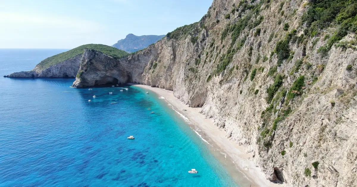 Speedboat at the mouth of a sea cave in clear turquoise water near Paleokastritsa on a Corfu boat tour